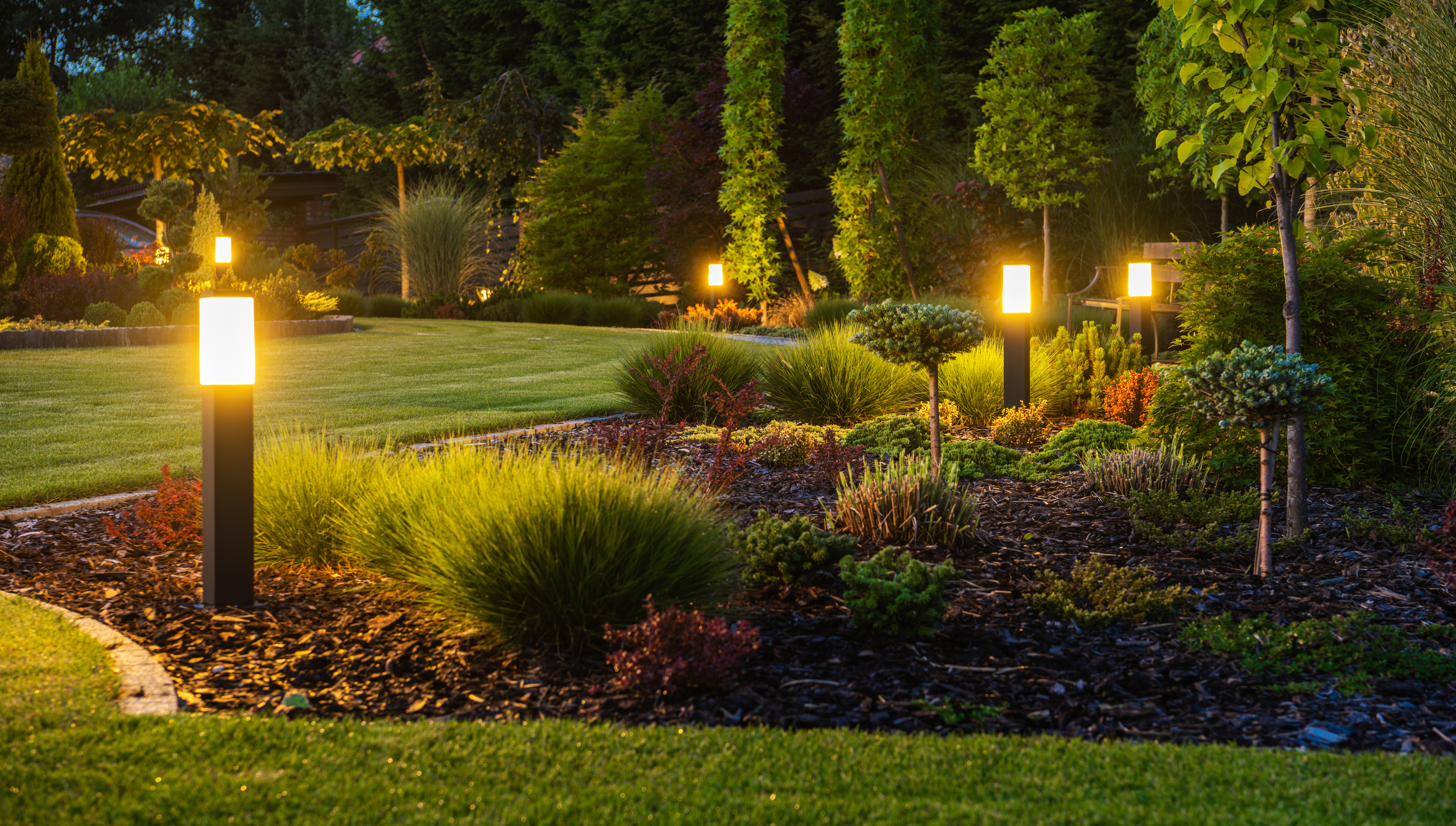 Professional LED landscape lighting installation illuminating a home in Spring, TX at night