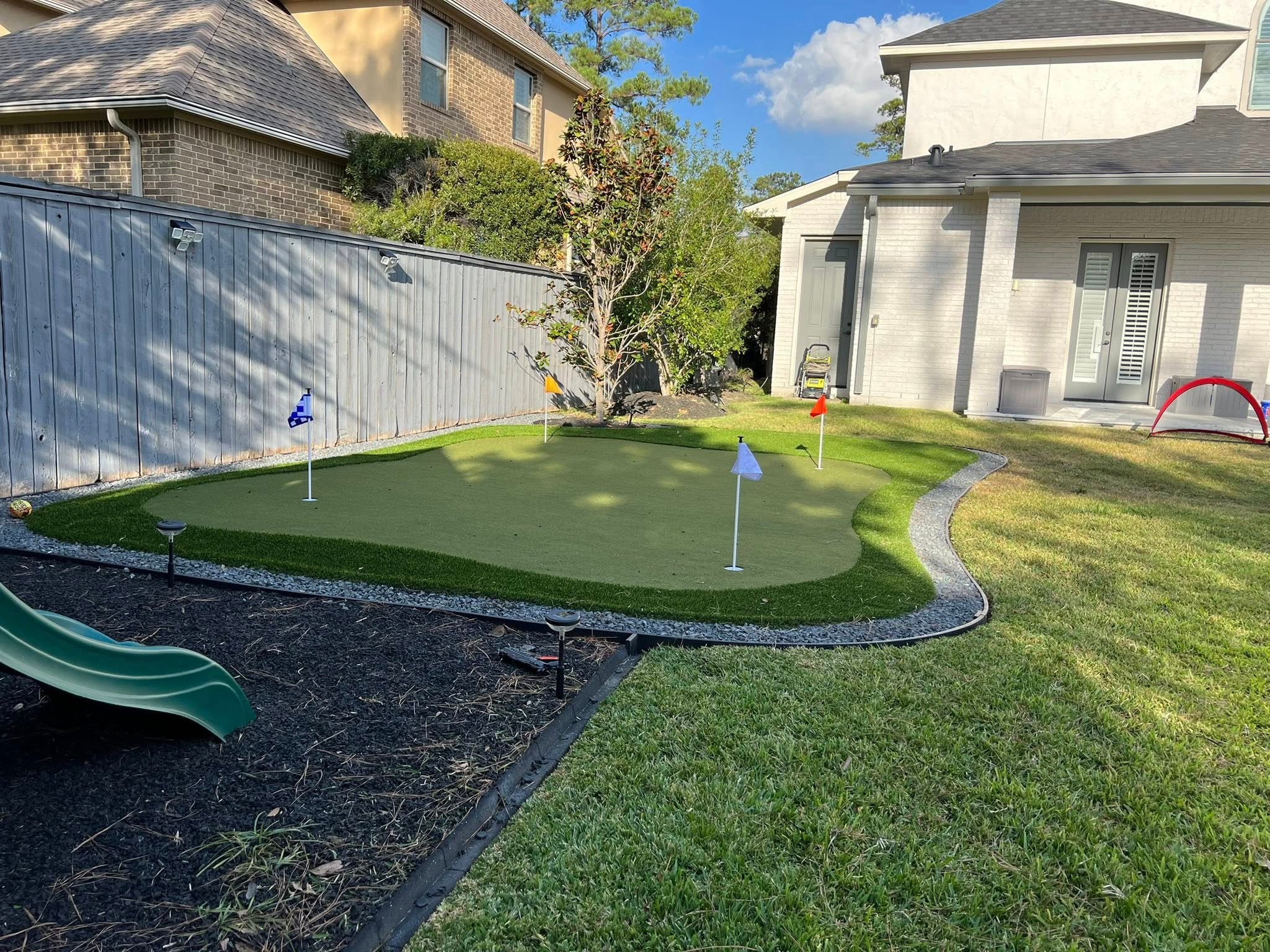 Custom artificial turf and backyard putting green installation in The Woodlands, TX
